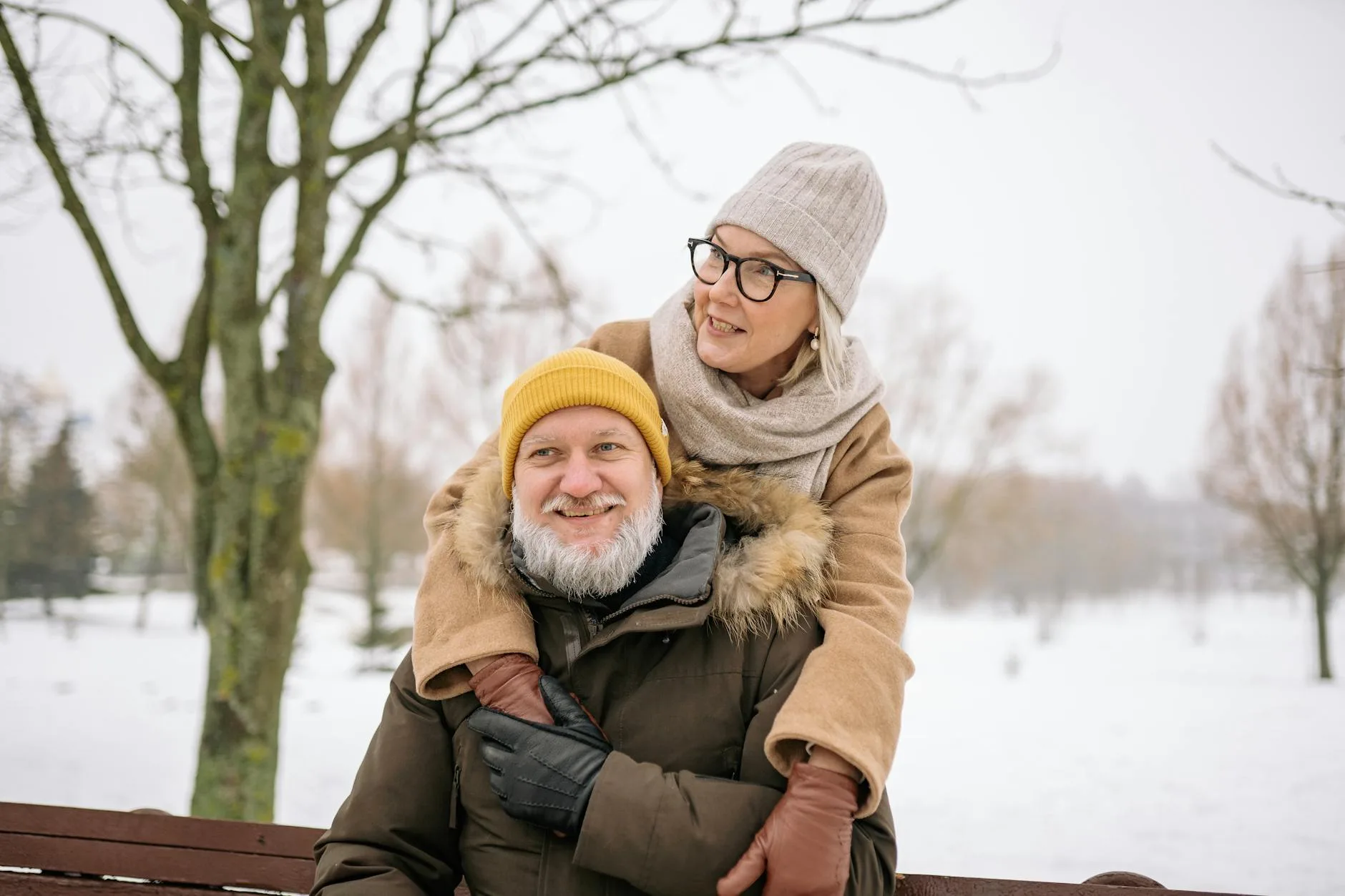 elderly man sitting by warm window in winter