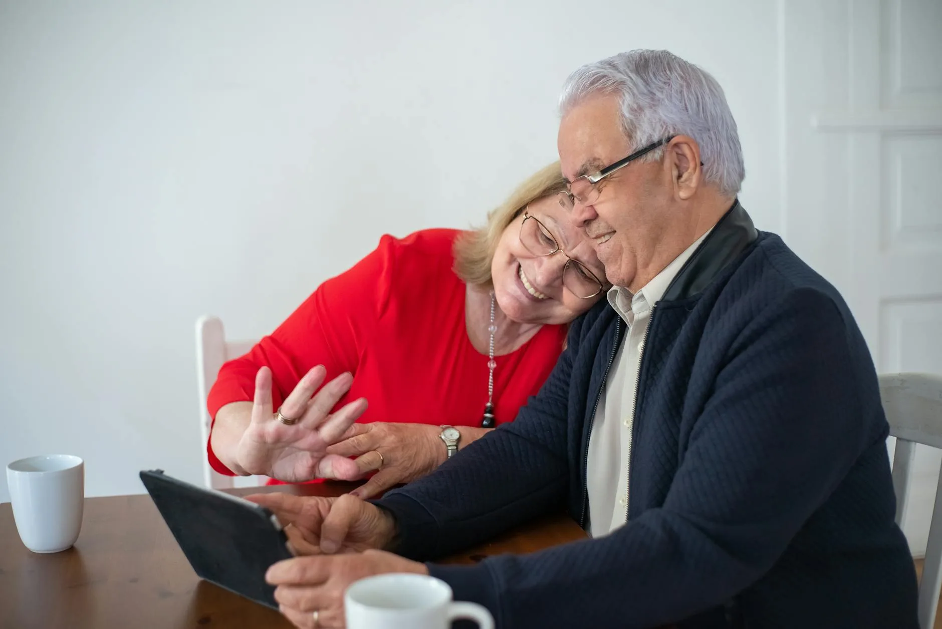 elderly woman sitting by window in winter light